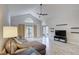 Spacious living room featuring vaulted ceiling, fan, recessed lighting, sliding doors and tile flooring at 643 Oregon Woods Ct, Orlando, FL 32824