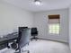 Home office with a large desk, rolling chairs, neutral walls, carpeted floor and natural light from the window at 643 Oregon Woods Ct, Orlando, FL 32824