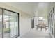 Covered patio featuring a dining table set and view of a serene outdoor space, accessed by sliding doors at 643 Oregon Woods Ct, Orlando, FL 32824