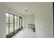 Bright porch featuring white walls, tiled floor, and glass windows and doors providing backyard view at 643 Oregon Woods Ct, Orlando, FL 32824