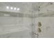 Modern shower with marble tile, dual shower heads, and glass enclosure at 643 Oregon Woods Ct, Orlando, FL 32824