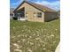 Rear view of home's facade with an enclosed patio and modest backyard at 1639 Stanbury Dr, Orlando, FL 32818