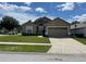 Charming single-Gathering home with a well-manicured lawn and attached two-car garage at 1639 Stanbury Dr, Orlando, FL 32818