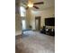 Spacious living room featuring neutral carpet, a high ceiling, and a bright front window at 1639 Stanbury Dr, Orlando, FL 32818