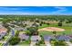 Beautiful aerial view of a gray roof home in a community with a golf course behind the property at 785 Hawks Bluff, Clermont, FL 34711