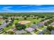 Gorgeous aerial view of a gray roof home in a community with a golf course behind the property at 785 Hawks Bluff, Clermont, FL 34711