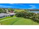 Scenic aerial view of a home on a golf course with mature trees and views of surrounding area at 785 Hawks Bluff, Clermont, FL 34711