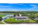 Aerial view of a clubhouse and golf course with beautiful landscaping and outdoor seating areas at 785 Hawks Bluff, Clermont, FL 34711