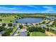 Overhead view of a home nestled in a golf community near a lake, with lush greenery at 785 Hawks Bluff, Clermont, FL 34711