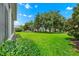 Backyard featuring lush green grass and mature landscaping at 785 Hawks Bluff, Clermont, FL 34711