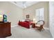 Cozy bedroom with neutral walls, ceiling fan, twin bed, accent chair and shuttered windows at 785 Hawks Bluff, Clermont, FL 34711