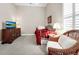 Inviting bedroom features a twin bed, wicker chair, dark wood dresser, and window with shutter at 785 Hawks Bluff, Clermont, FL 34711