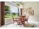 Dining room with large window overlooking the lawn, a chandelier, and traditional furniture at 785 Hawks Bluff, Clermont, FL 34711