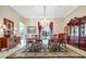 Formal dining room with a chandelier, decorative rug, and ornate wooden furniture at 785 Hawks Bluff, Clermont, FL 34711