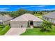 Charming home featuring a well-manicured lawn, a two-car garage, and lush landscaping at 785 Hawks Bluff, Clermont, FL 34711