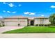 Beautifully landscaped home featuring a two-car garage and charming curb appeal at 785 Hawks Bluff, Clermont, FL 34711
