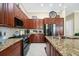 Well-equipped kitchen boasting granite countertops, a gas range, and stainless steel appliances at 785 Hawks Bluff, Clermont, FL 34711