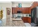 Spacious kitchen featuring granite counters, wood cabinets, and stainless steel appliances at 785 Hawks Bluff, Clermont, FL 34711