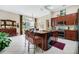 Gourmet kitchen with granite island, stainless appliances, and adjacent dining area at 785 Hawks Bluff, Clermont, FL 34711