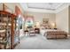 Spacious main bedroom with tray ceiling, neutral walls, floral bedding, cabinet and large windows at 785 Hawks Bluff, Clermont, FL 34711