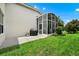 Outdoor patio area with a grill and a screened enclosure, perfect for entertaining at 785 Hawks Bluff, Clermont, FL 34711