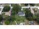 An aerial view of a property with a spacious lot, mature trees, and lush green landscaping at 1405 Ridgegreen N Loop, Lakeland, FL 33809
