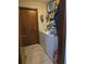 A laundry room featuring a washer, dryer, and shelving for convenient storage at 1405 Ridgegreen N Loop, Lakeland, FL 33809
