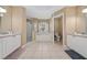 Primary bathroom featuring dual sinks, a walk-in shower and a soaking tub under a window at 344 Barbera Dr, Davenport, FL 33897