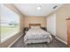 Cozy bedroom featuring hardwood floors, a window and a closet at 344 Barbera Dr, Davenport, FL 33897