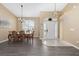 Bright dining area featuring a wood table, stylish chairs, and a modern chandelier at 344 Barbera Dr, Davenport, FL 33897