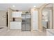 Spacious kitchen with stainless steel refrigerator and access to laundry room at 344 Barbera Dr, Davenport, FL 33897