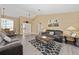Inviting living room with vaulted ceiling, wood laminate flooring, and lots of natural light at 344 Barbera Dr, Davenport, FL 33897