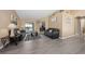 Open living room with gray couches, wood-look flooring and sliding doors to the pool area at 344 Barbera Dr, Davenport, FL 33897
