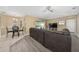 Living area featuring tile floors, a brown sofa, and view to the backyard through sliding glass doors at 344 Barbera Dr, Davenport, FL 33897