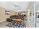 Relaxing living room features tile floors, sliders to screened in patio and plenty of sunshine at 344 Barbera Dr, Davenport, FL 33897