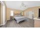 Bright main bedroom with wood-look floors, ceiling fan and sliding door to the outdoors at 344 Barbera Dr, Davenport, FL 33897