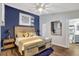 Beautiful bedroom featuring rustic wood furniture, a blue accent wall, and modern decor at 571 Nogales Ct, Kissimmee, FL 34758