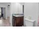 Half bath featuring a dark wood vanity with a granite countertop at 311 Pop Top Ln, Daytona Beach, FL 32124