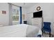 Bright bedroom with a ceiling fan, full dresser, and comfortable chair at 311 Pop Top Ln, Daytona Beach, FL 32124