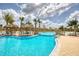 Large community pool area with thatched umbrellas, island seating, and a charming bridge connecting the different sections at 311 Pop Top Ln, Daytona Beach, FL 32124