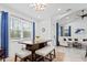 Cozy dining area features a modern table with bench seating, large window and stylish lighting fixture at 311 Pop Top Ln, Daytona Beach, FL 32124