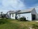 Side view of the house shows the two car garage and nice yard at 311 Pop Top Ln, Daytona Beach, FL 32124