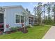 Charming cottage-style home with well-manicured lawn and screened porch at 311 Pop Top Ln, Daytona Beach, FL 32124