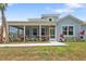 Inviting curb appeal with a spacious screened-in porch perfect for enjoying a relaxing afternoon at 311 Pop Top Ln, Daytona Beach, FL 32124