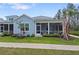 Charming single-Gathering home featuring a spacious, screened-in front porch and well-manicured landscaping at 311 Pop Top Ln, Daytona Beach, FL 32124
