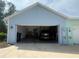 A large two car garage with extra storage and a car parked inside at 311 Pop Top Ln, Daytona Beach, FL 32124