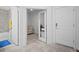 Hallway showcasing a full bathroom, office space, and access to the main living area at 311 Pop Top Ln, Daytona Beach, FL 32124