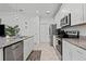 Modern kitchen featuring granite countertops, stainless steel appliances, and ample cabinet space at 311 Pop Top Ln, Daytona Beach, FL 32124