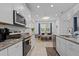Bright kitchen features granite countertops, white cabinetry, and a dining area with natural light at 311 Pop Top Ln, Daytona Beach, FL 32124