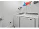 Modern laundry room with new washer and dryer and storage shelf at 311 Pop Top Ln, Daytona Beach, FL 32124